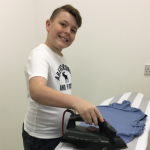 student ironing a tshirt