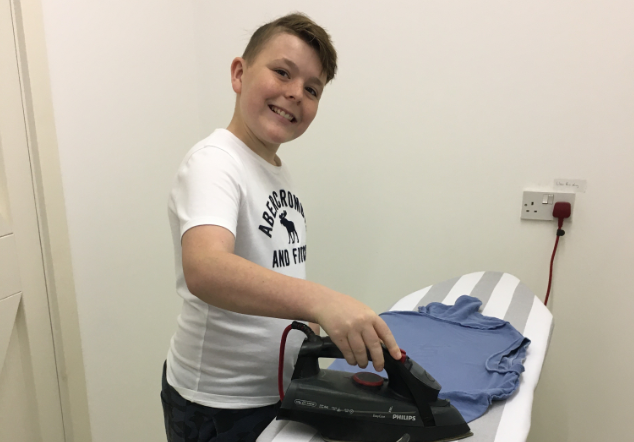 student ironing a tshirt