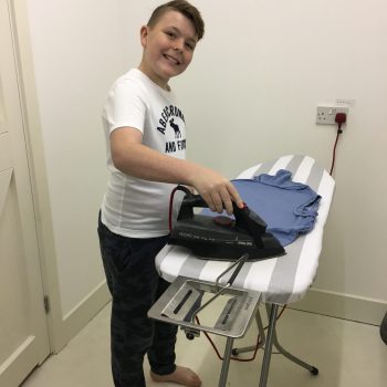 student ironing clothes