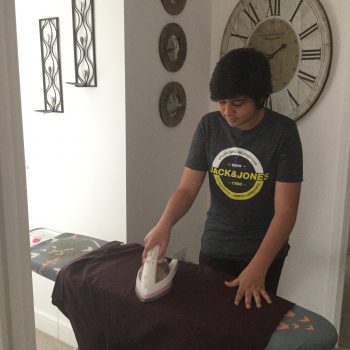 student ironing clothes
