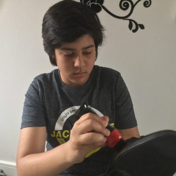student polishing his shoes