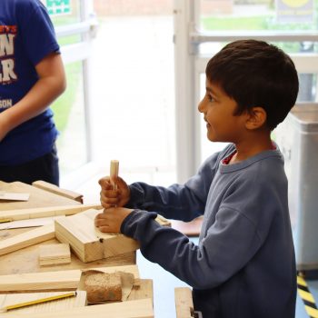 A child working on a wood work project at a boys school in Chesham