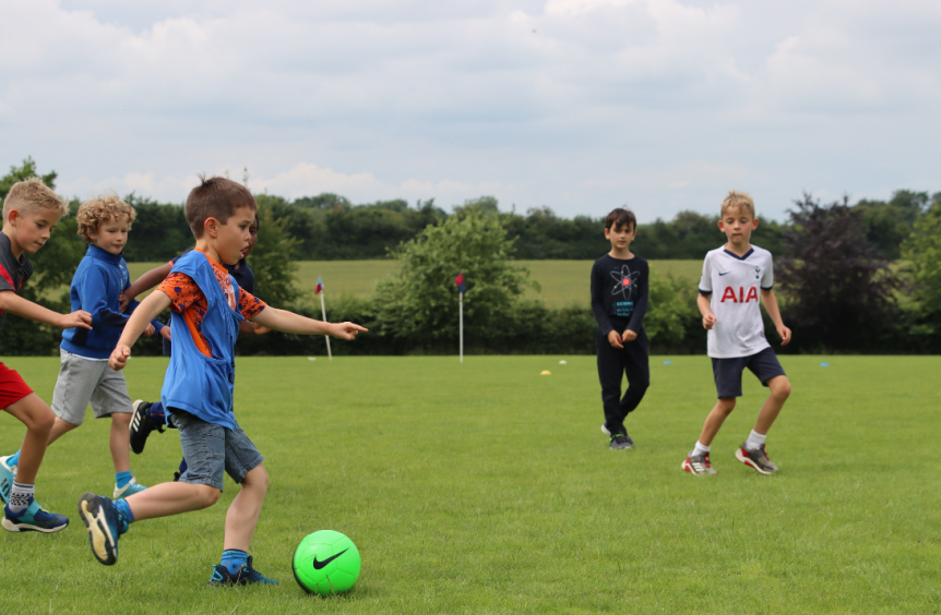 boys playing football on a field at a boys school in Chesham