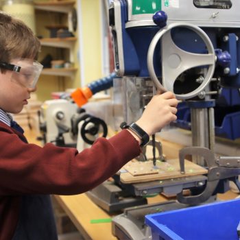 child using a wood carving machine