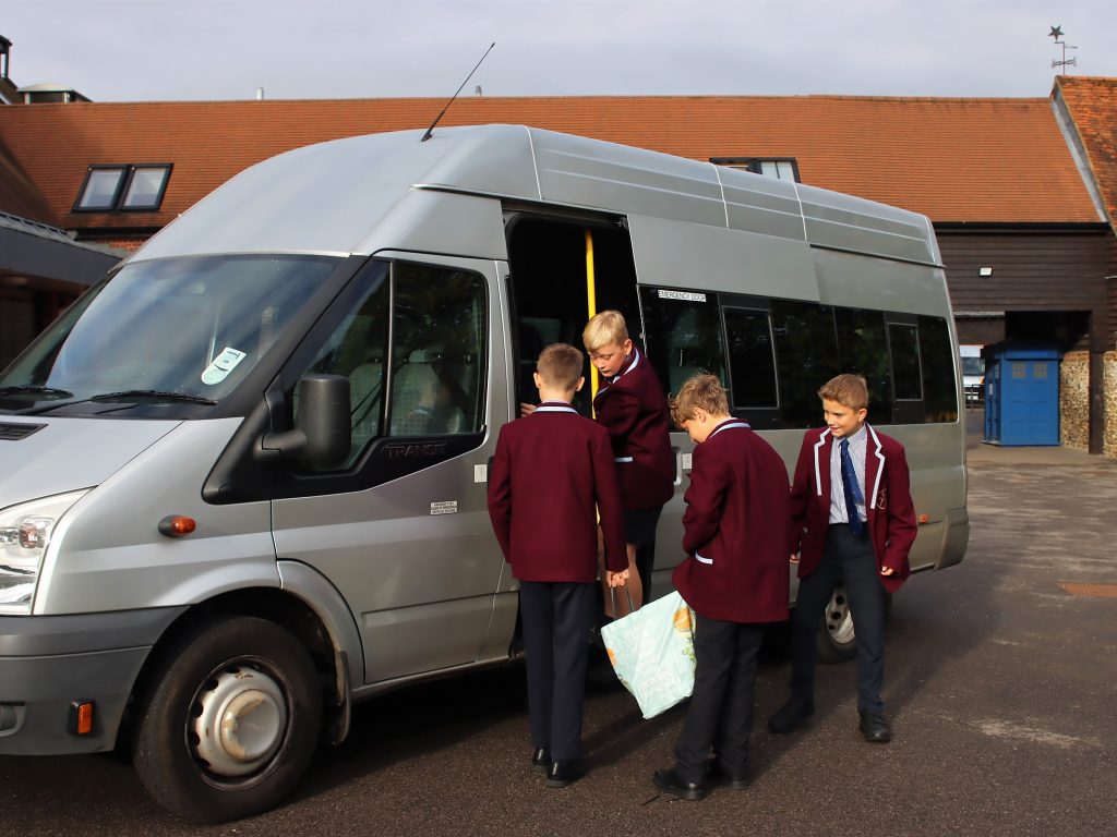 children getting on to a minibus