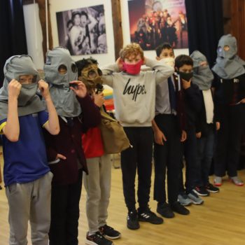 Students wearing balaclavas and gas masks