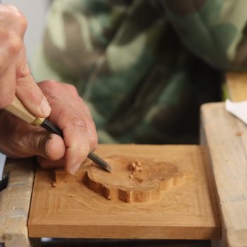 Wood being carved into