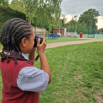 student taking a photo of the school field