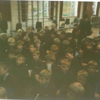 Assembly in the old School Hall circa 1987-8 with Mr David Foster (Latin) seated in the background
