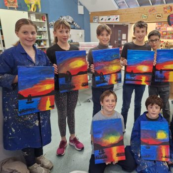 children showing off their canvases of work