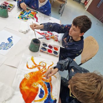 students painting together in the classroom