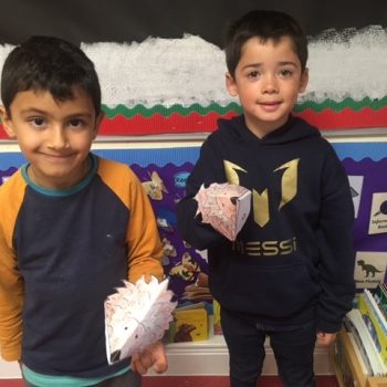 2 students with their paper hedgehog creations