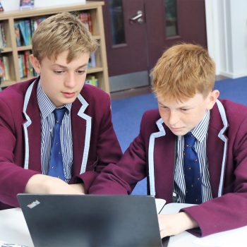 2 students using a laptop