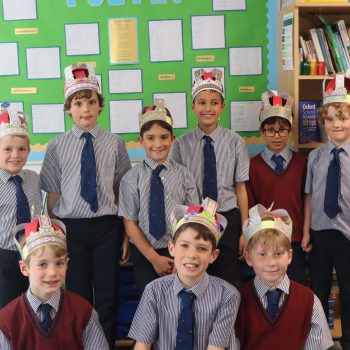 group of boys wearing crowns