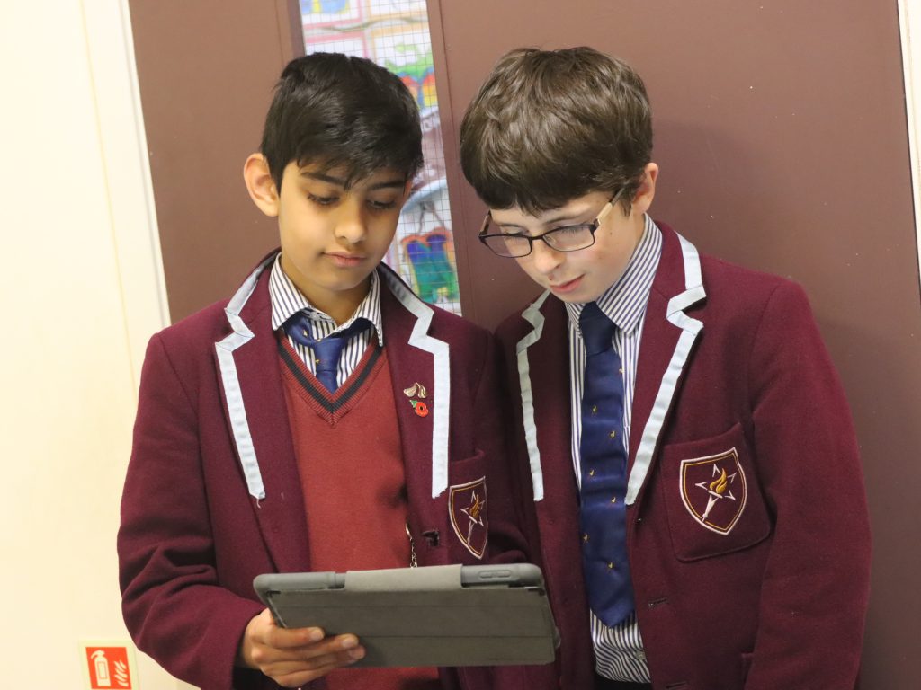 2 students reading from an iPad