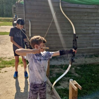 boy using a bow and arrow