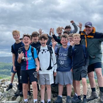 group of students on the top of a mountain