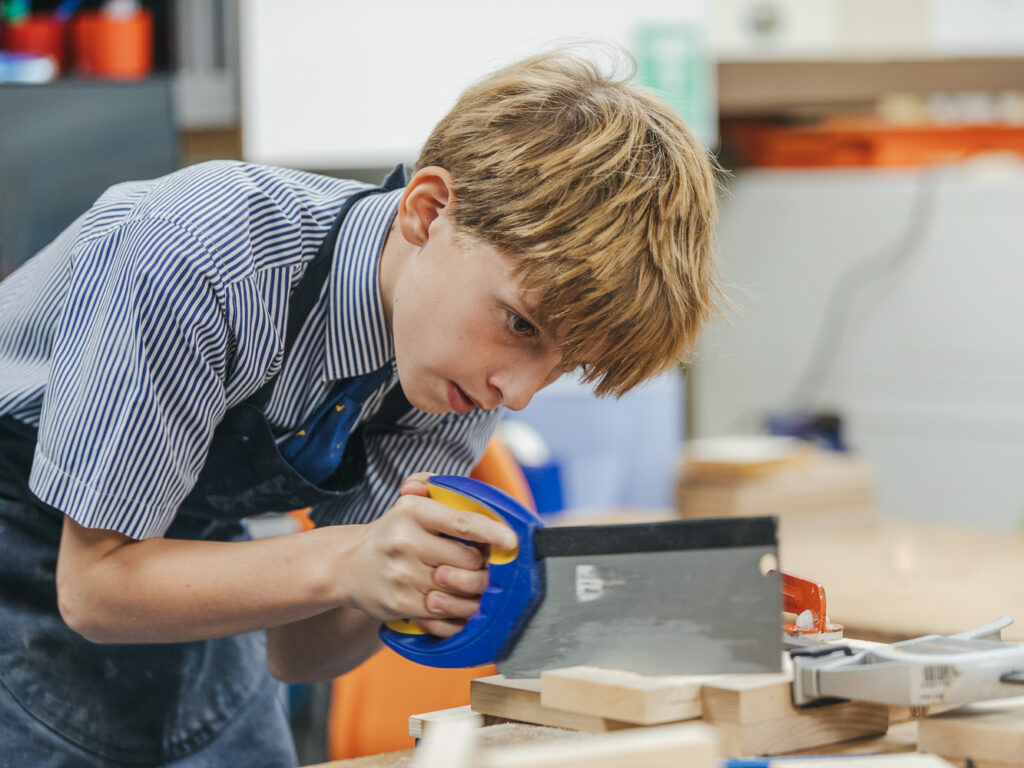 student using a saw